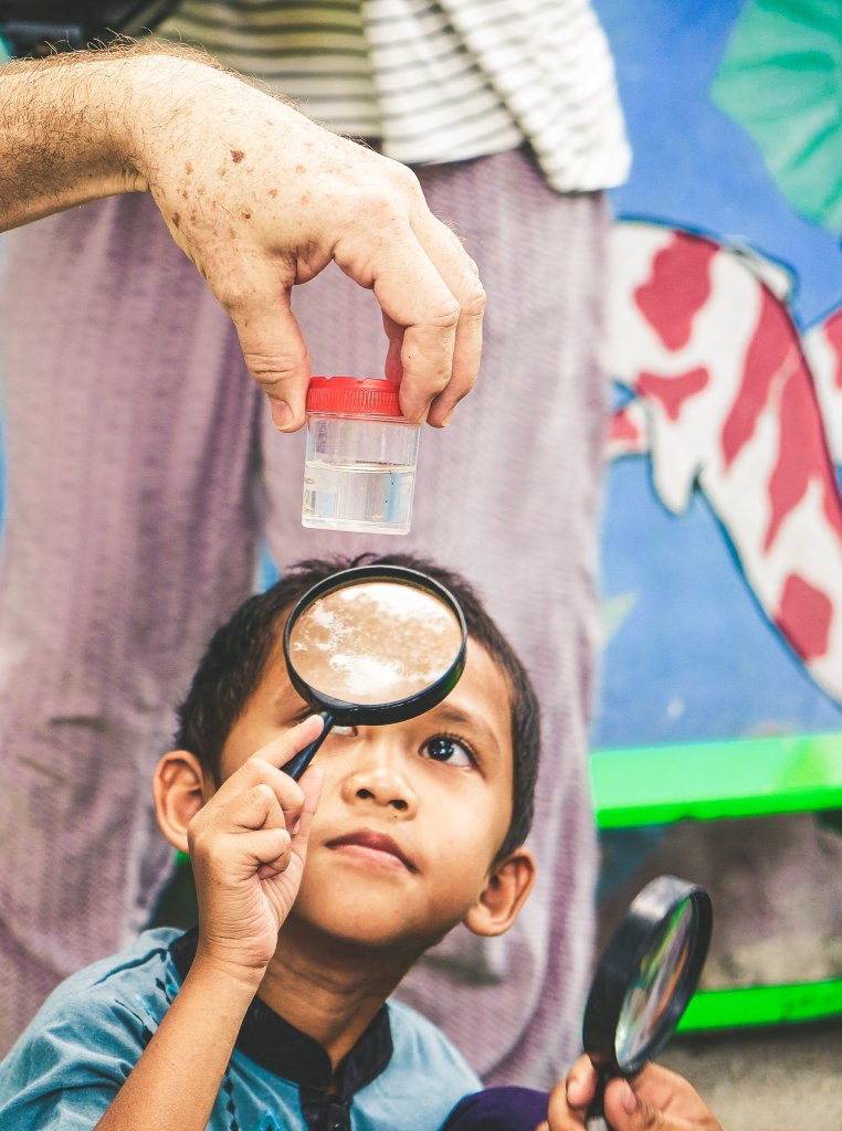 A local student scrutinizes a mosquito larva infected with Wolbachia. Pic courtesy WMP Yogyakarta